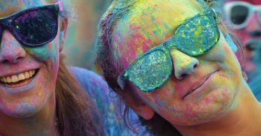 girl with sunglasses and coloured powder