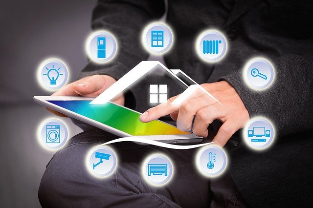 man on tablet with icons domotics