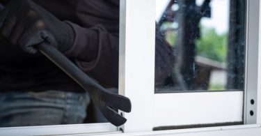 robber breaking in through window
