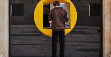 A person withdrawing money from his bank account at an ATM. Photo: Manuel via Unsplash